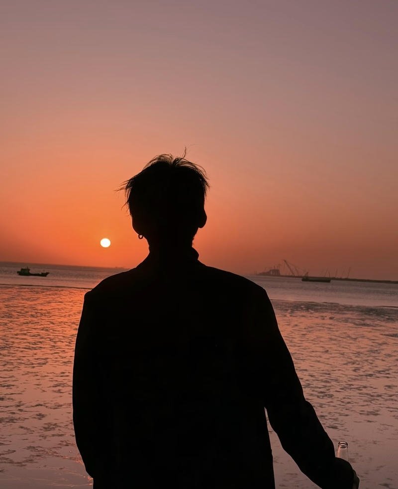 Ánh sáng mờ trong ảnh nam chụp sau lưng tạo chiều sâu